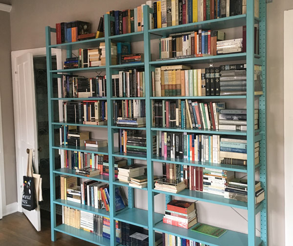 A wall of turquoise bookshelves